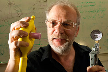 University of Chicago physicist Heinrich Jaeger uses a soft gripper to hold up a vial
